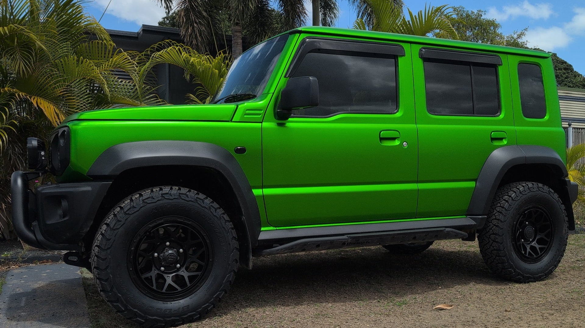 Green Suzuki Jimny (2023+) fitted with Satin Black Magpie M-01 Wheels