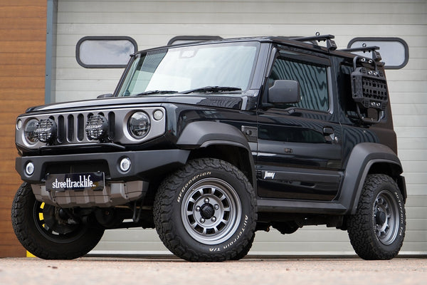 Black Suzuki Jimny (2018+) with APIO Tactical Bumpers (front and rear) and SJ grille. Vehicle is also fitted with 16" HIGH PEAK J-01 wheels in Matte Anthracite and BF Goodrich KO2 tyres