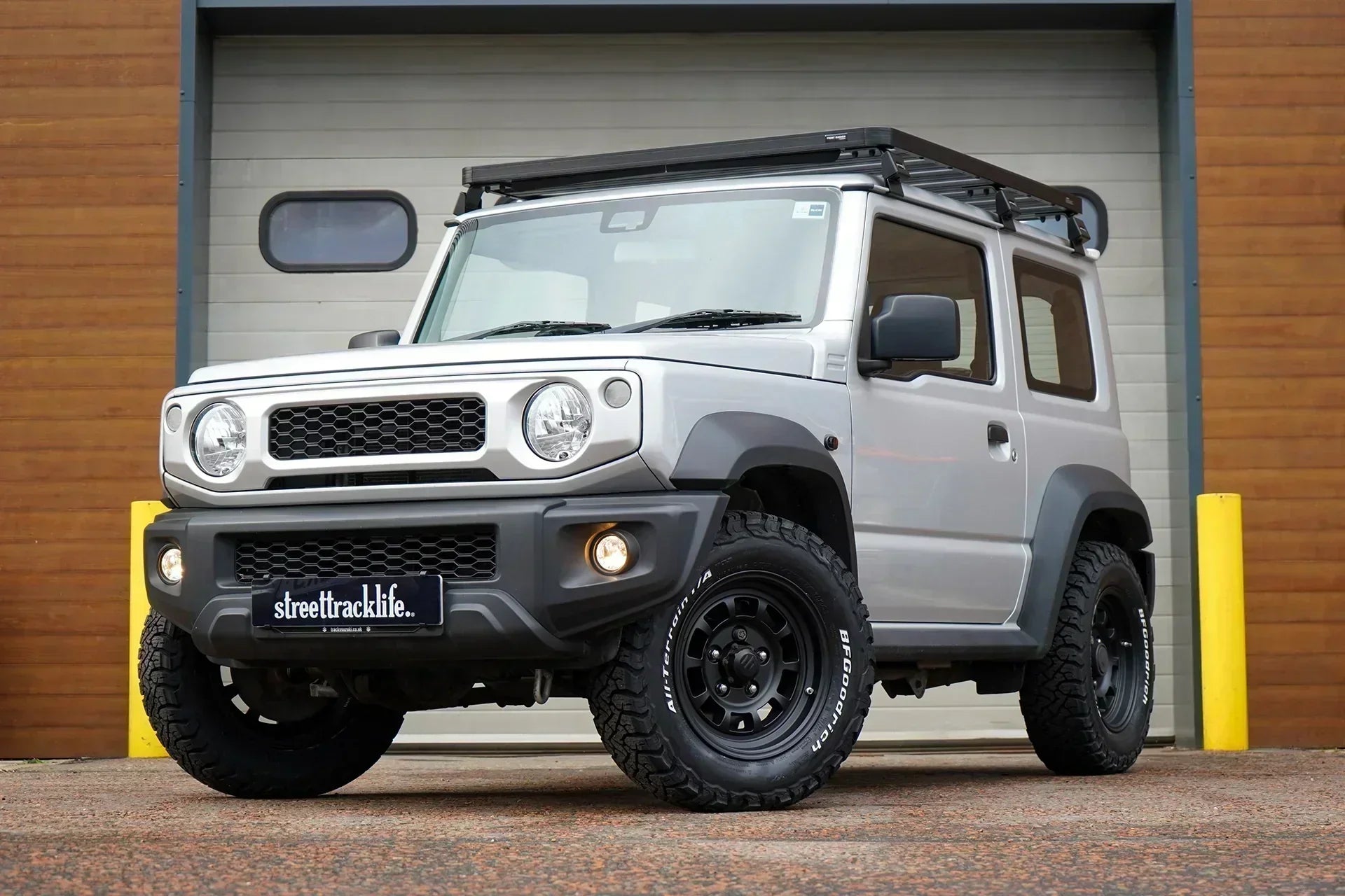 Suzuki Jimny (2018+) with 16" High Peak J-01 wheels in Matte Black, with BF Goodrich KO3 tyres, Front Runner Slimline II Roof Rack and JIMNYSTYLE LED Lights