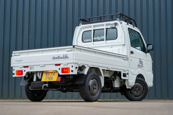 Mitsubishi minicab kei truck with xtreme-J 14 inch wheels and a hard cargo roof basket